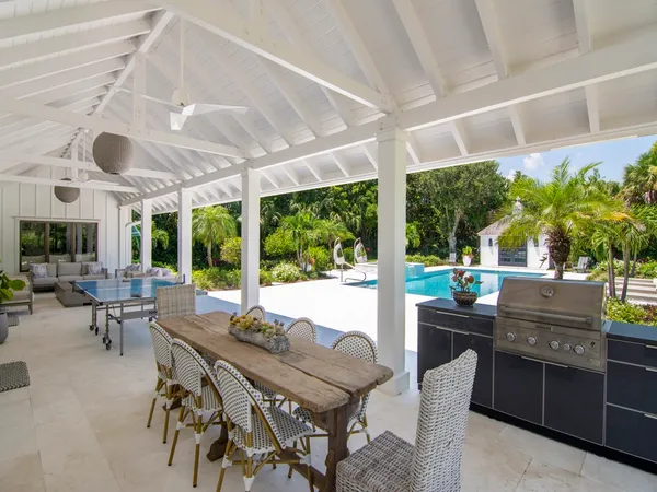 a view of a patio with a dining table and chairs