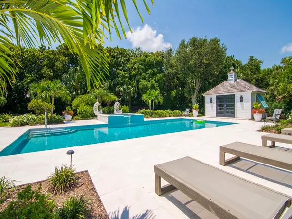 a view of an house with swimming pool and yard