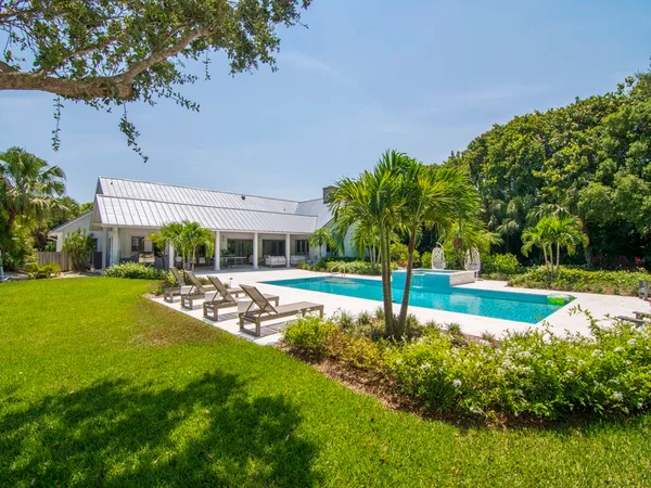 a view of a house with a yard balcony and sitting area