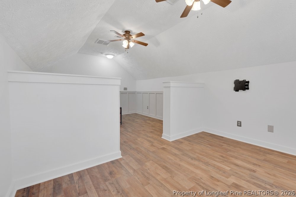 408 Senter Lane Spring Lake, NC 28390 - Photo 14 of 30 an empty room with wooden floor chandelier fan and windows