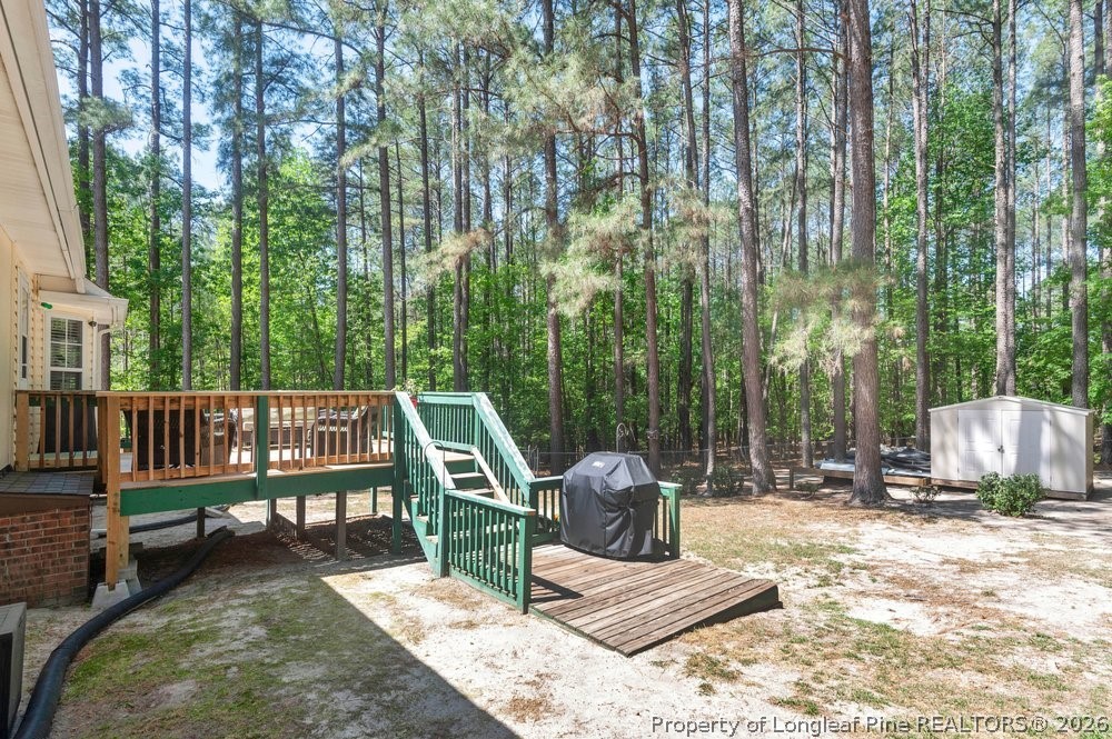 408 Senter Lane Spring Lake, NC 28390 - Photo 19 of 30 a view of a deck with a chairs and wooden fence