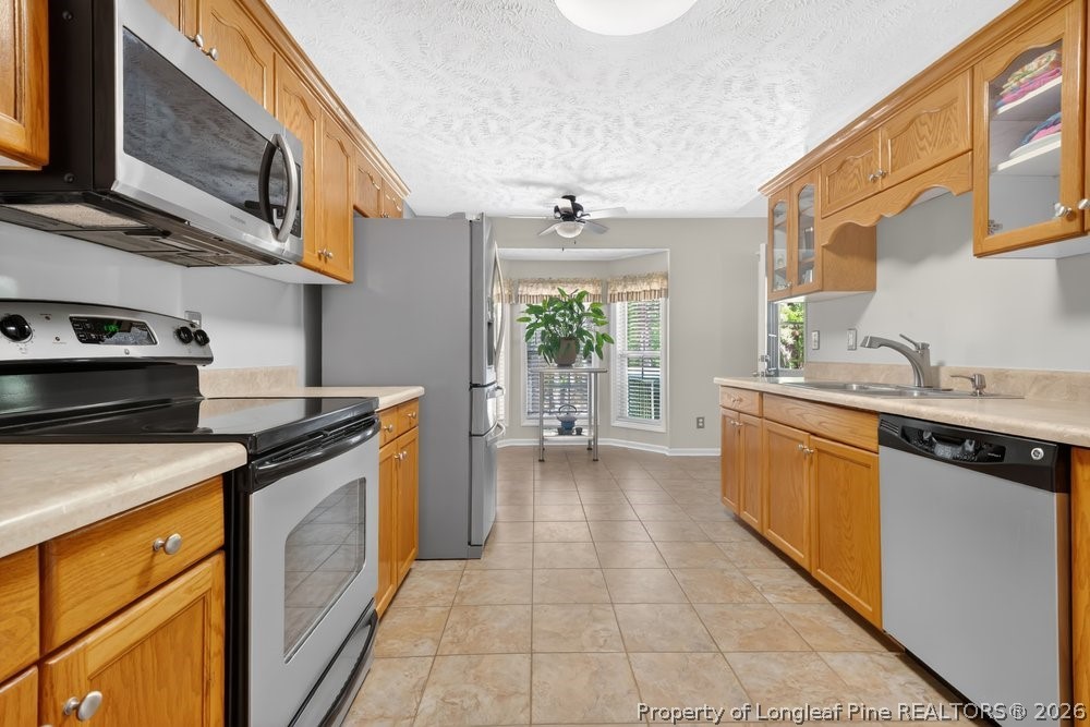 408 Senter Lane Spring Lake, NC 28390 - Photo 5 of 30 a kitchen with a stove top oven sink and cabinets