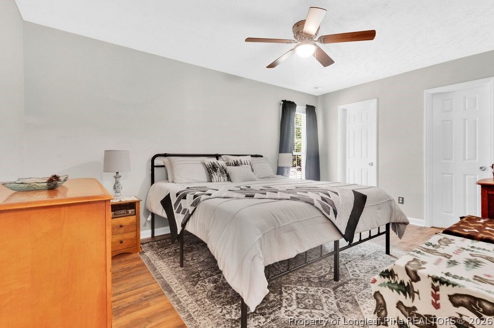 408 Senter Lane Spring Lake, NC 28390 - Photo 6 of 30 a bed sitting in a bedroom next to a window and a chandelier
