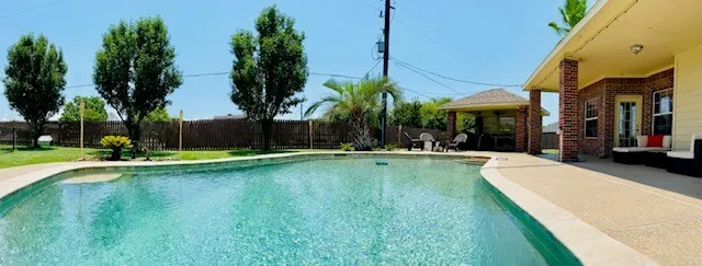 a view of swimming pool with a table and chairs