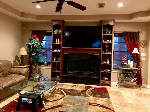 a living room with furniture a flat screen tv and a fireplace