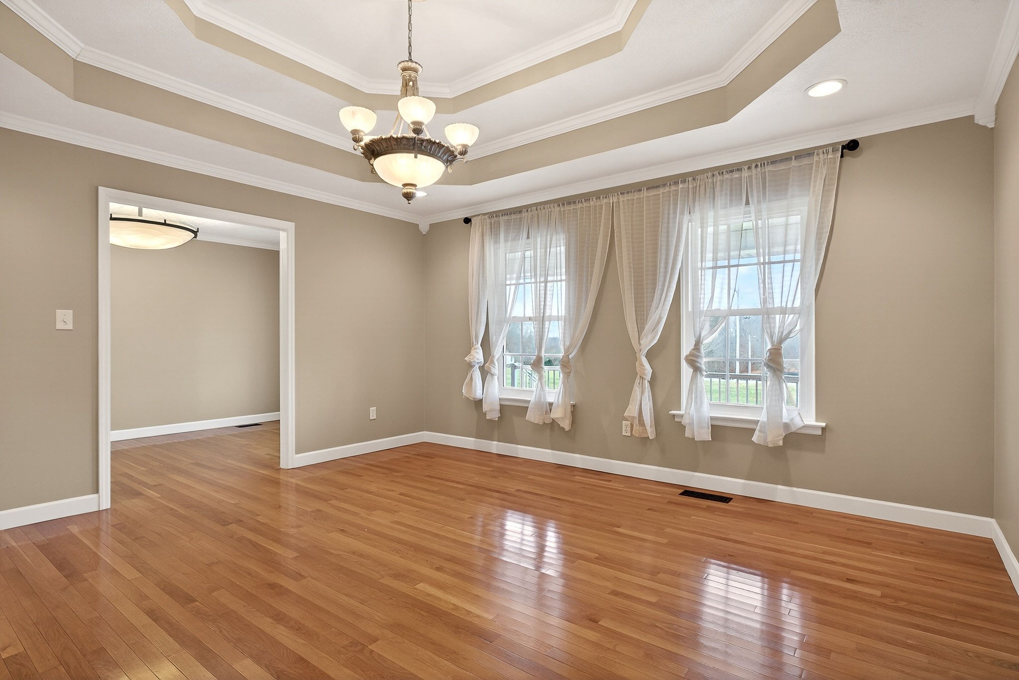 2408 Shellsford Road McMinnville, TN 37110 - Photo 8 of 60 an empty room with wooden floor chandelier fan and windows