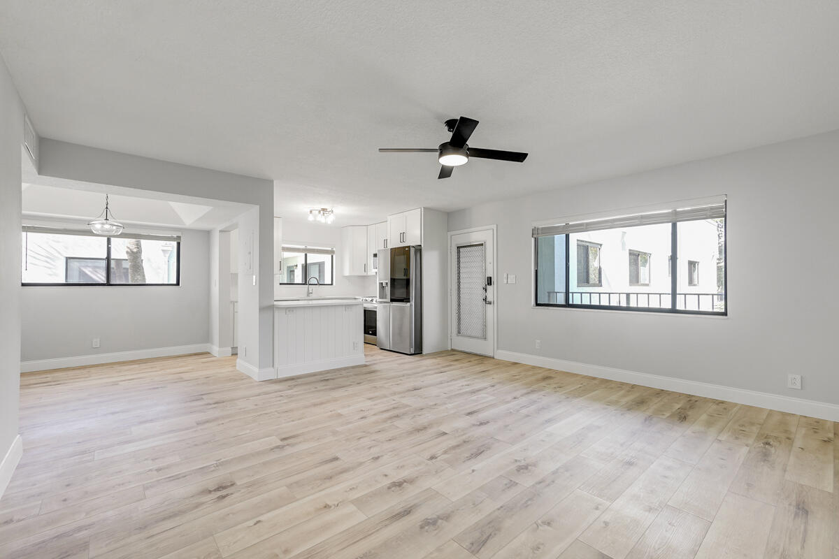 15072 Ashland Place, Unit 132 Delray Beach, FL 33484 - Photo 11 of 38 a view of an empty room with a window and wooden floor