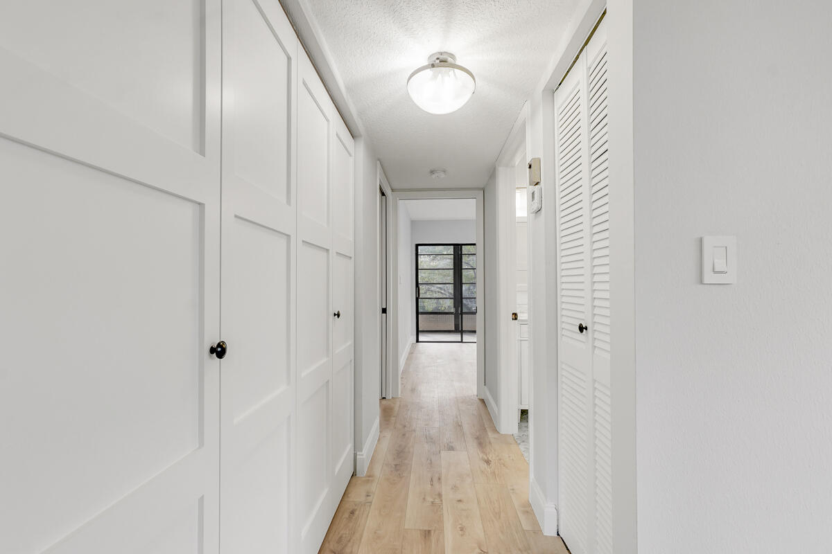 15072 Ashland Place, Unit 132 Delray Beach, FL 33484 - Photo 13 of 38 a view of a hallway with wooden floor and staircase