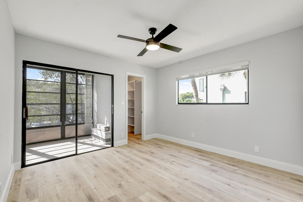 15072 Ashland Place, Unit 132 Delray Beach, FL 33484 - Photo 20 of 38 a view of an empty room with glass door