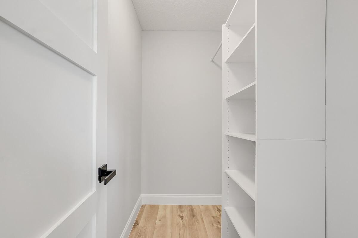 15072 Ashland Place, Unit 132 Delray Beach, FL 33484 - Photo 22 of 38 a view of walk in closet with empty racks