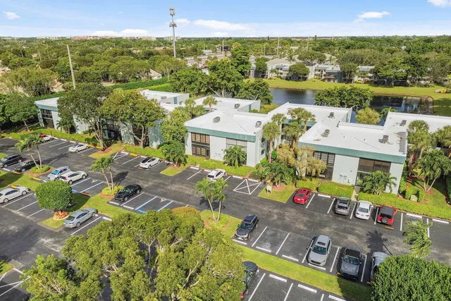 an aerial view of residential houses with outdoor space and river