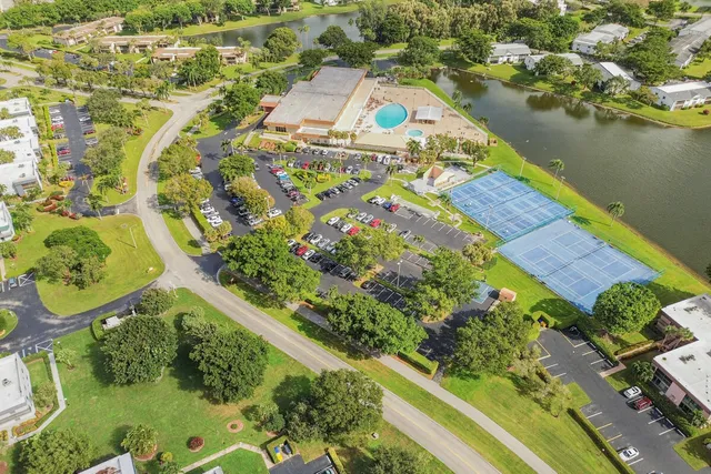 an aerial view of a house with a yard and lake view