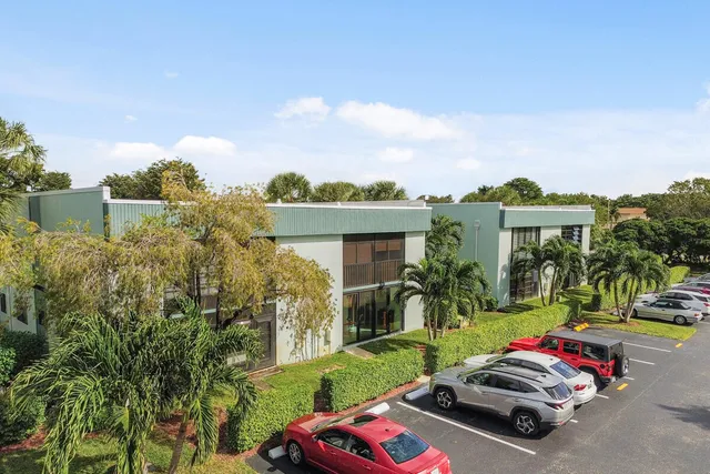 a view of a house with a yard and a garden
