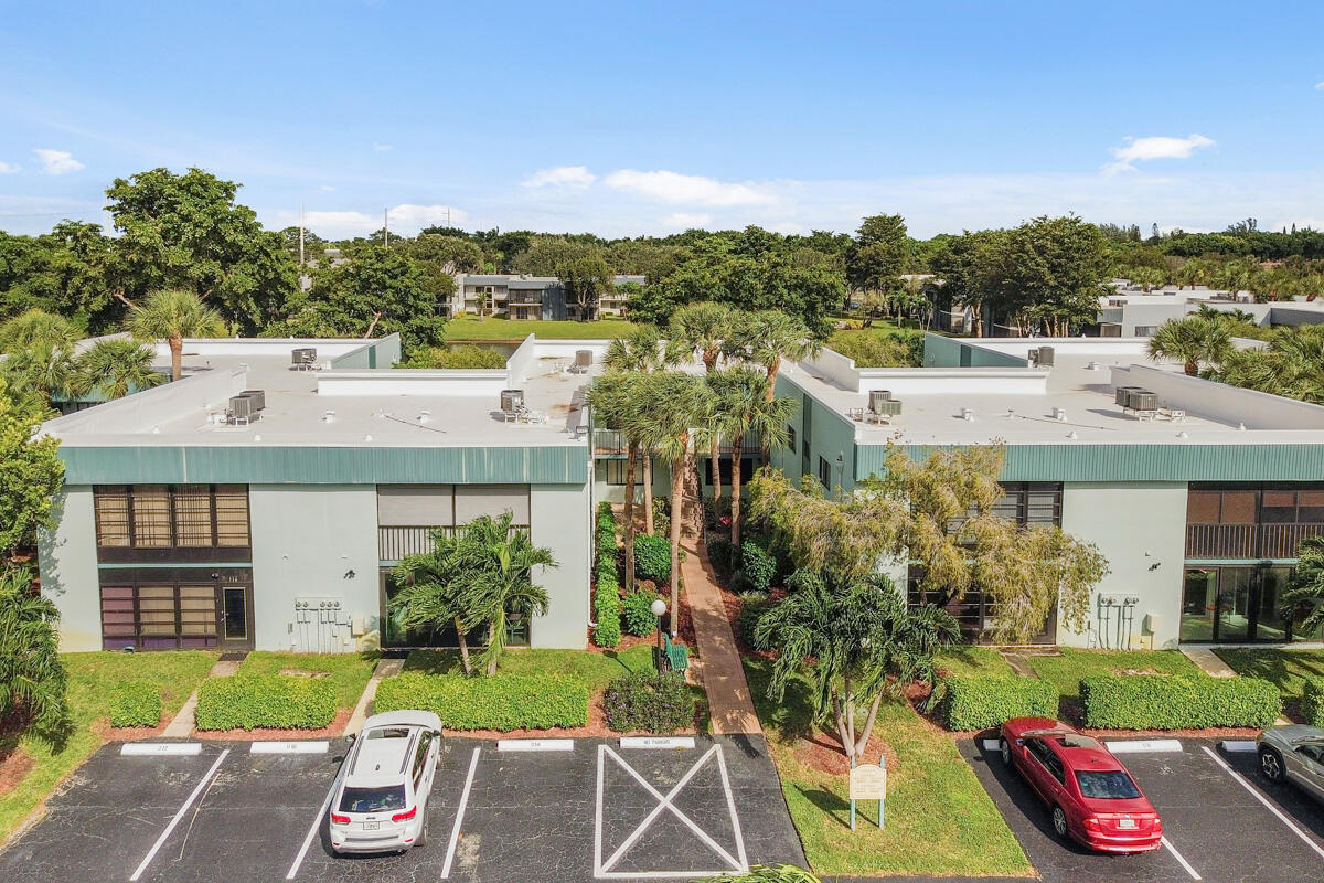 15072 Ashland Place, Unit 132 Delray Beach, FL 33484 - Photo 37 of 38 a view of a house with a yard and a garden