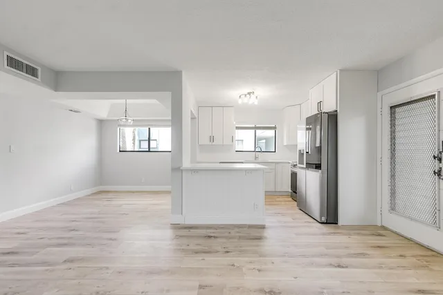 a view of a kitchen with wooden floor and a kitchen