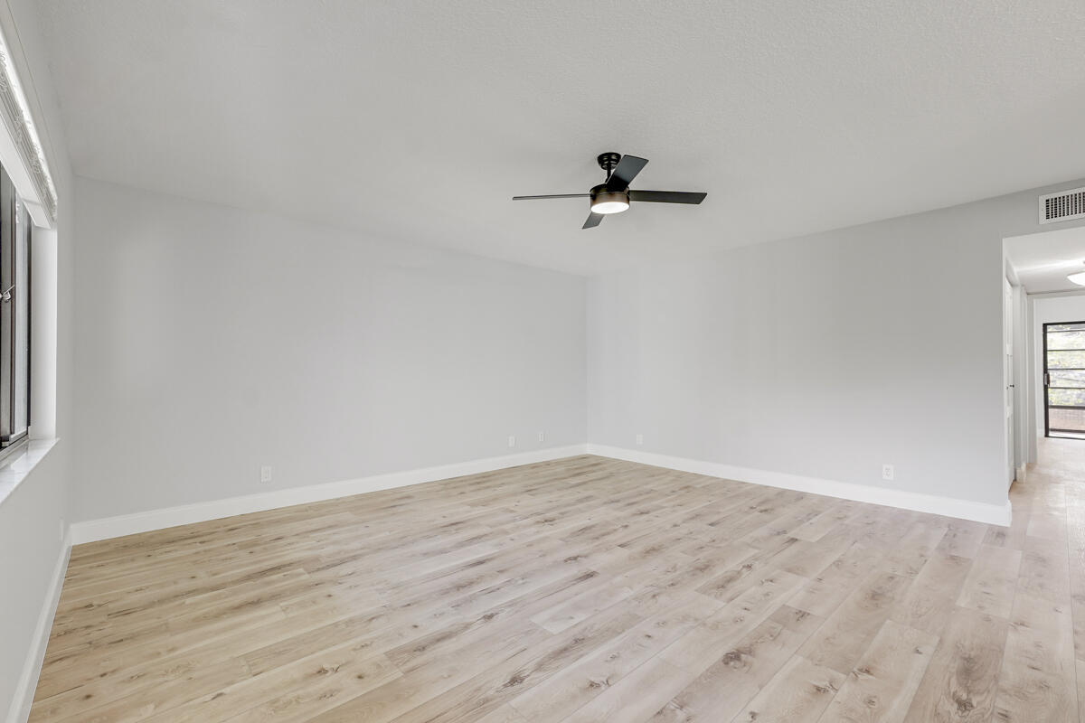 15072 Ashland Place, Unit 132 Delray Beach, FL 33484 - Photo 9 of 38 wooden floor in an empty room
