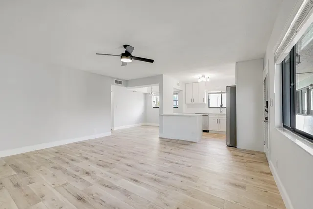 a view of a kitchen with wooden floor and a kitchen