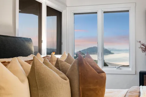 a bedroom with a bed and large window