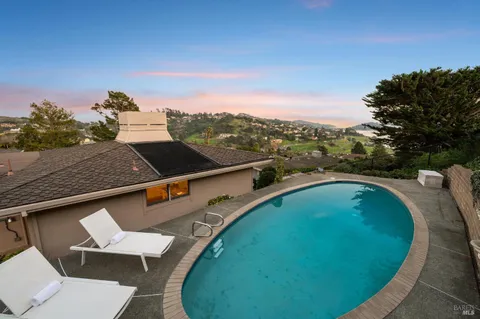 an aerial view of a house with a garden and trees