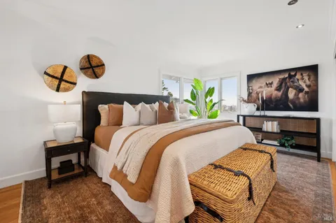 a bedroom with a bed and a flat screen tv