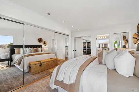 a bedroom with a large bed and a walk in closet