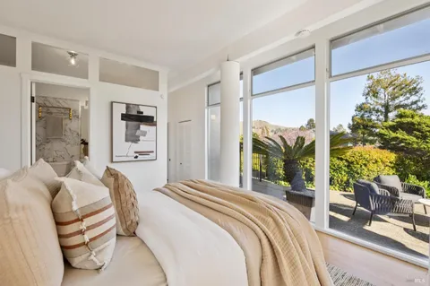 a bedroom with a bed and a potted plant