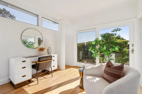 a living room with furniture and a potted plant