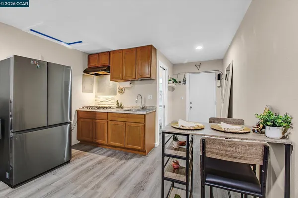 a kitchen with stainless steel appliances a refrigerator and a stove top oven