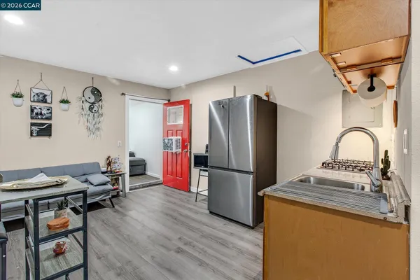 a kitchen with stainless steel appliances a refrigerator and a stove top oven