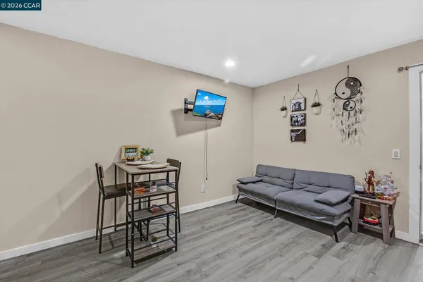 a living room with furniture a couch and a flat screen tv