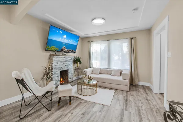 a living room with furniture a fireplace and a flat screen tv