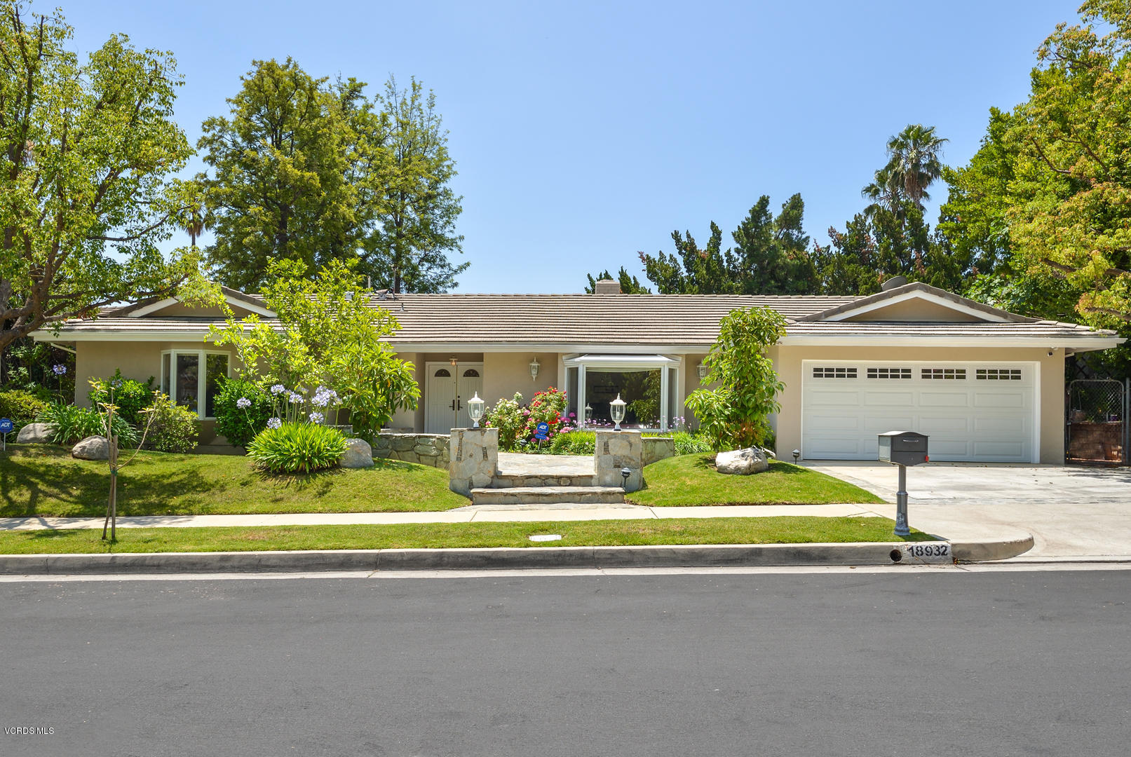 18932 Olympia Street Porter Ranch, CA 91326 - Photo 1 of 39 a front view of a house with a yard and garage