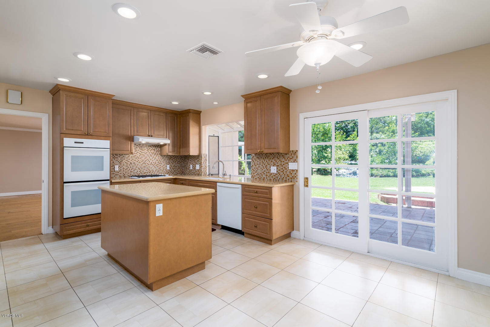 18932 Olympia Street Porter Ranch, CA 91326 - Photo 13 of 39 a kitchen with a refrigerator a sink and cabinets