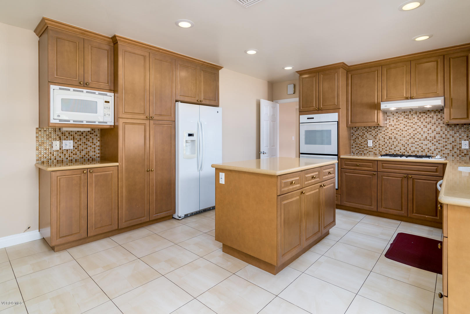 18932 Olympia Street Porter Ranch, CA 91326 - Photo 14 of 39 a kitchen with stainless steel appliances granite countertop a refrigerator and a stove