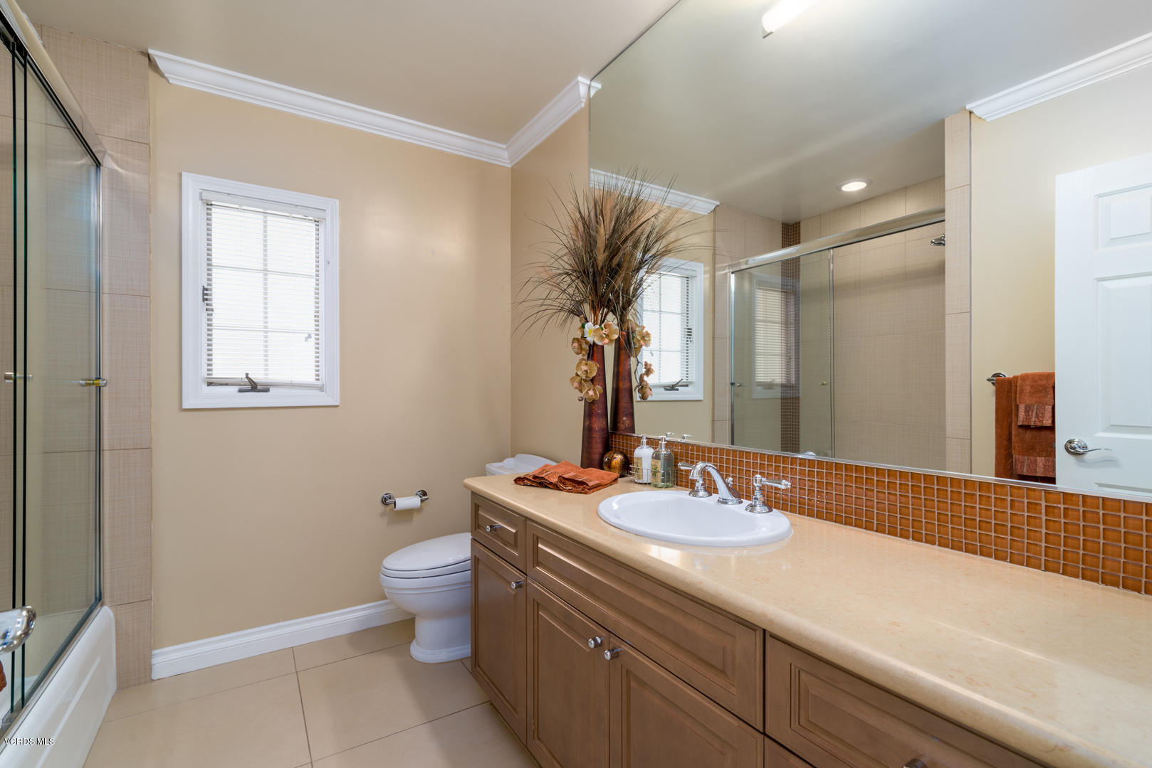 18932 Olympia Street Porter Ranch, CA 91326 - Photo 31 of 39 a bathroom with a granite countertop sink a toilet and a mirror