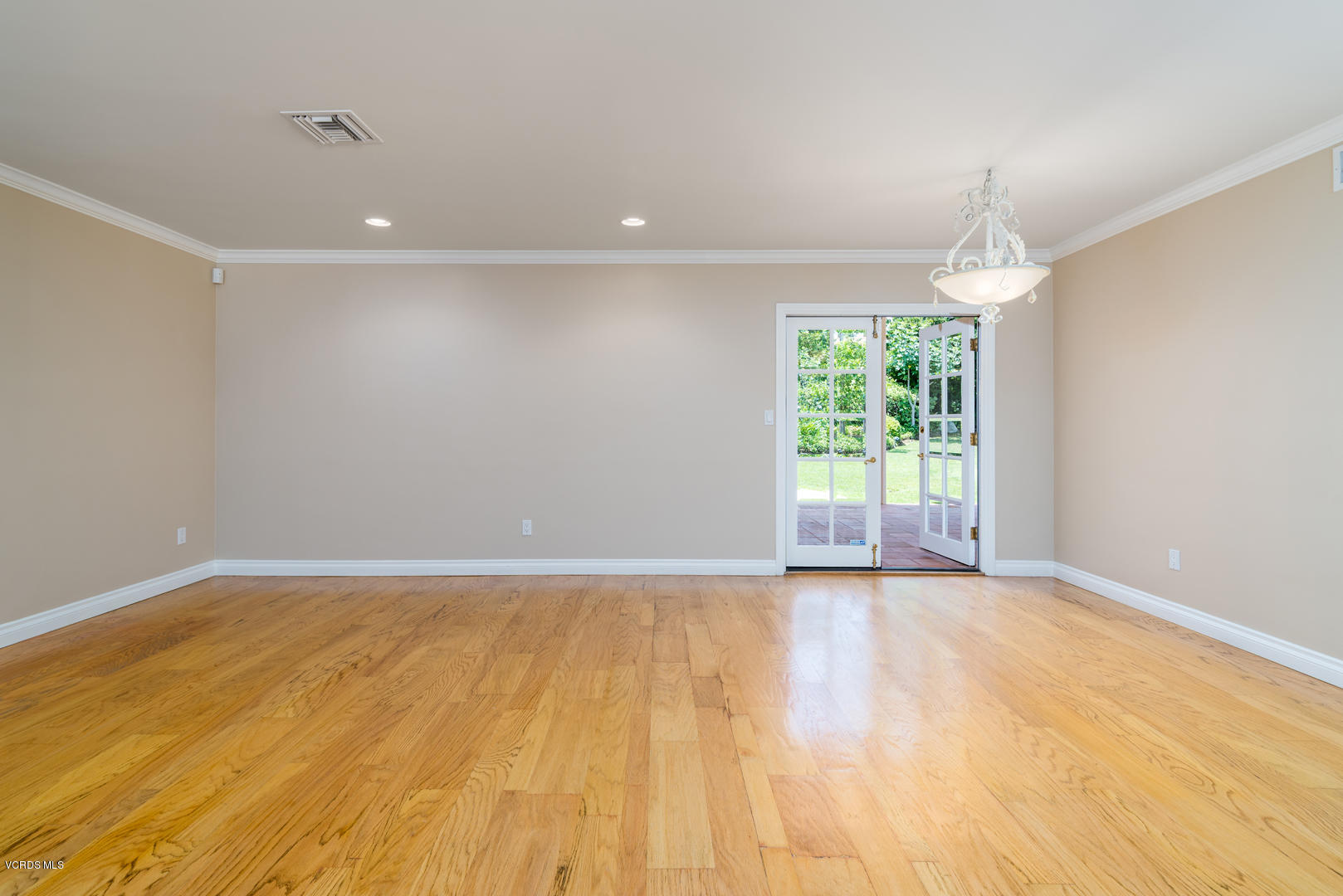 18932 Olympia Street Porter Ranch, CA 91326 - Photo 10 of 39 a view of an empty room with wooden floor and a window