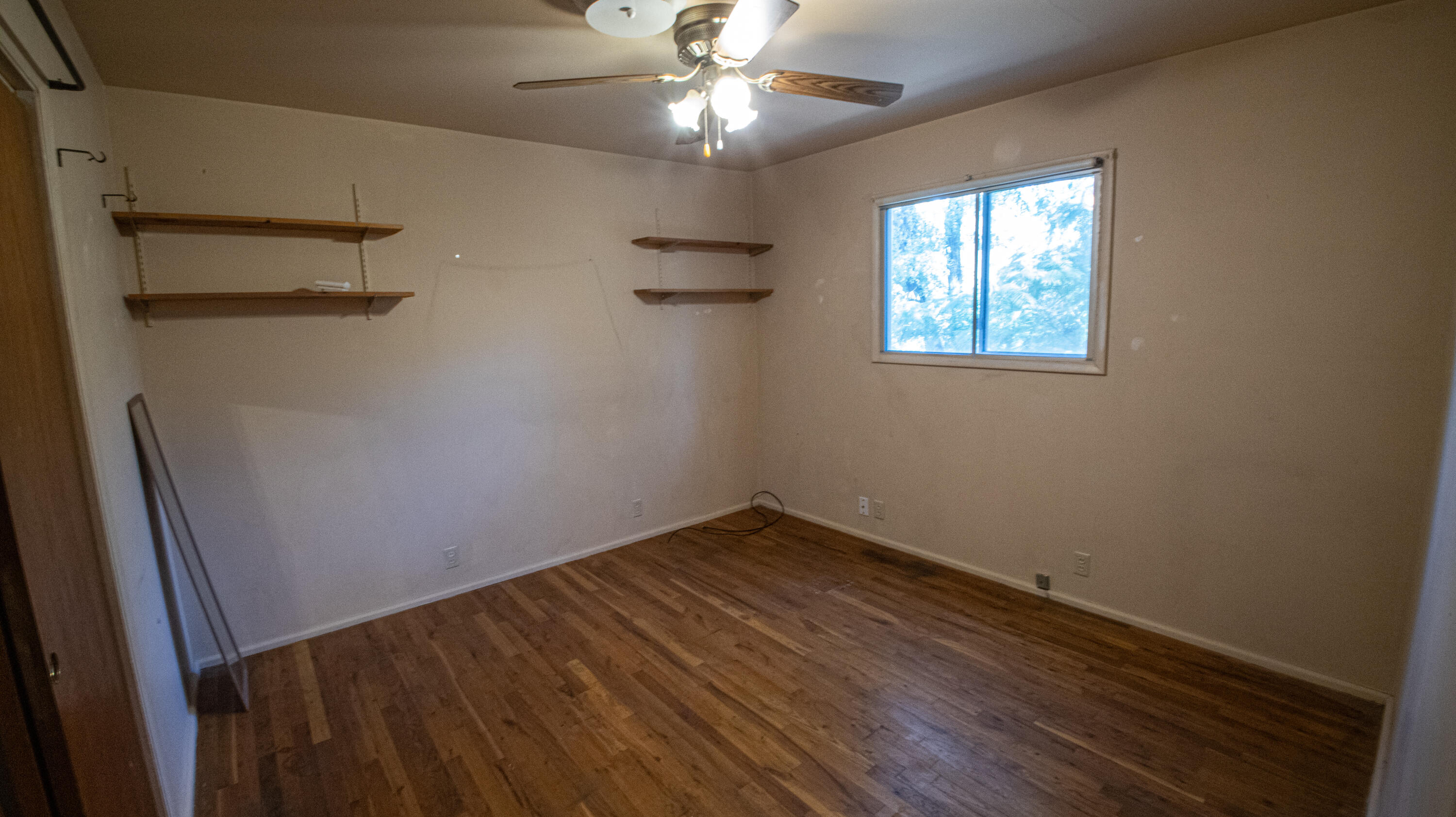 17768 Irish Road Redding, CA 96003 - Photo 9 of 17 an empty room with windows and fan