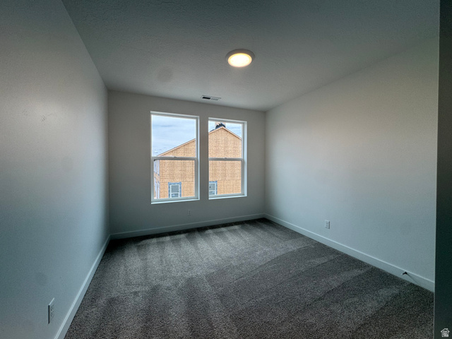 1876 West 1575th North, Unit 237 Layton, UT 84041 - Photo 12 of 20 Spare room featuring dark carpet and baseboards
