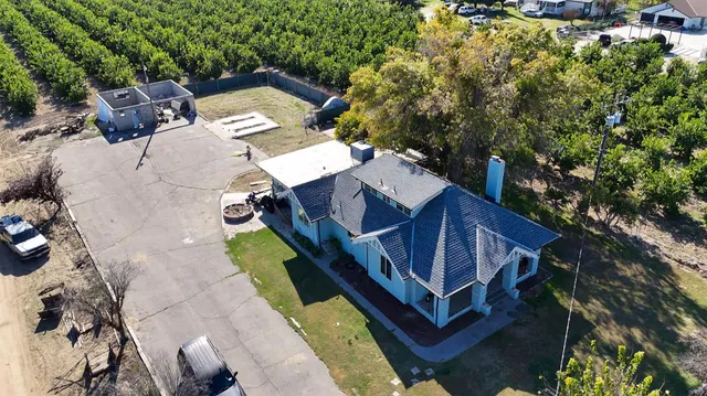 a view of a house with a yard and sitting area