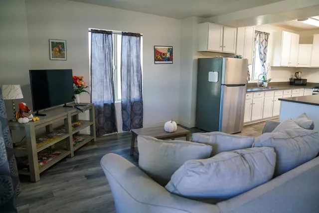 a living room with furniture and a flat screen tv
