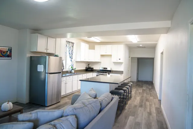 a kitchen with a refrigerator a sink and a stove
