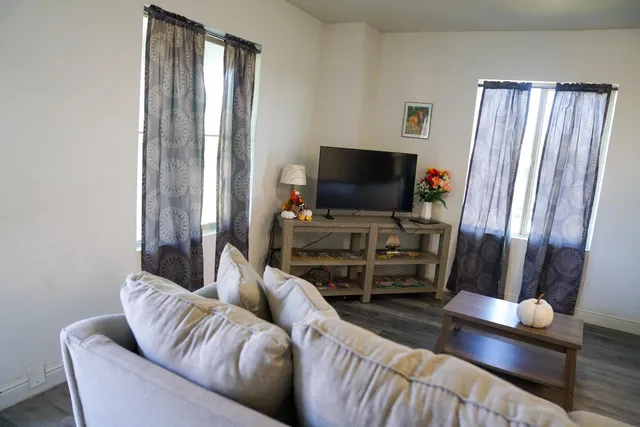 a living room with furniture and a flat screen tv