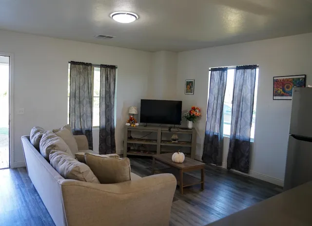 a living room with furniture and a flat screen tv