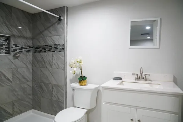 a bathroom with a sink toilet and shower