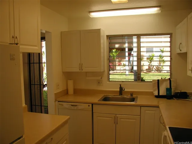 a kitchen with a sink and refrigerator