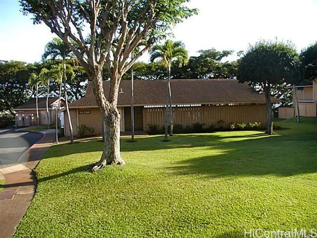 a view of a house with a backyard
