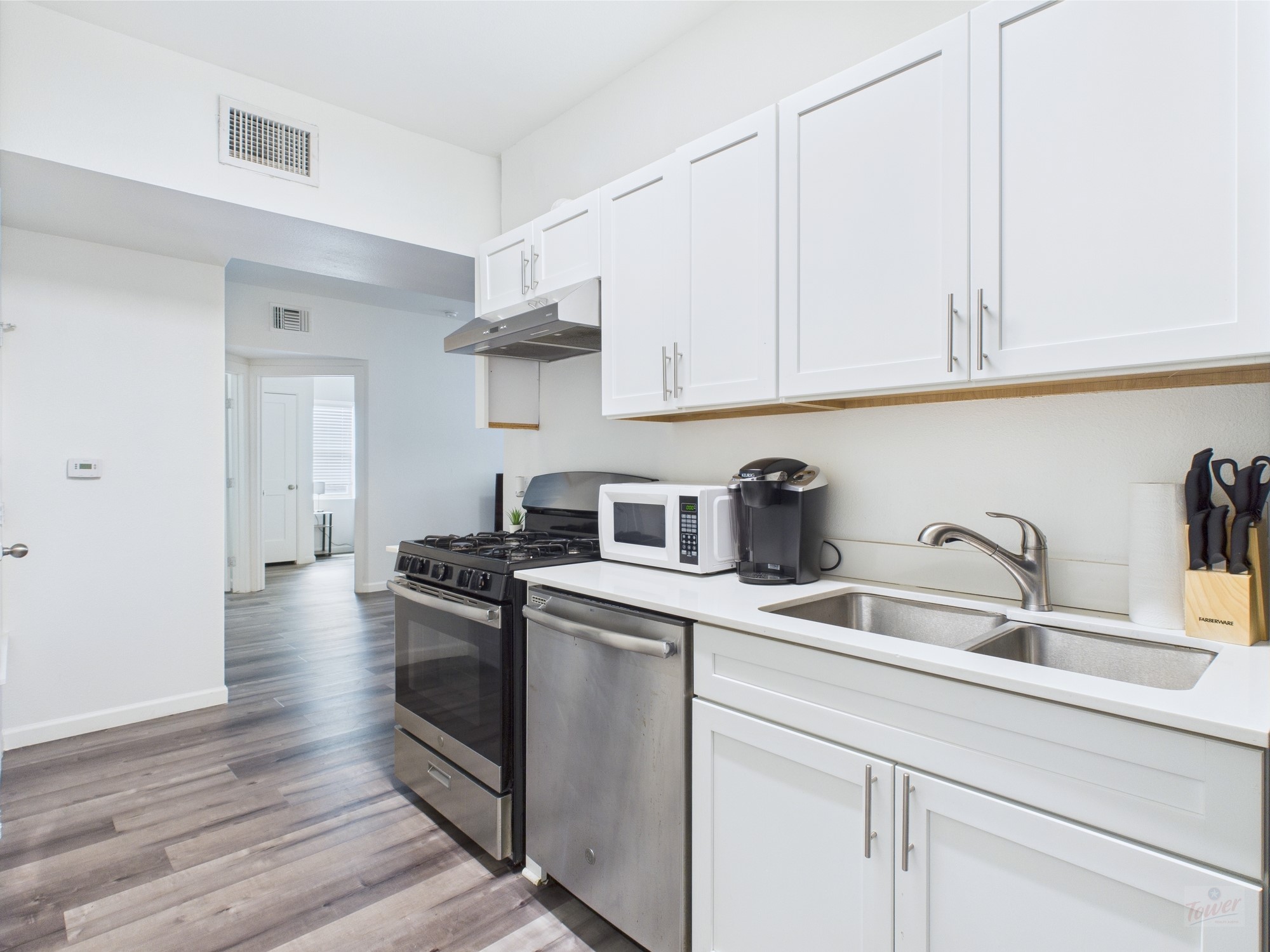911 West 22nd Street, Unit 306 Austin, TX 78705 - Photo 1 of 12 a kitchen with stainless steel appliances granite countertop a sink stove and refrigerator