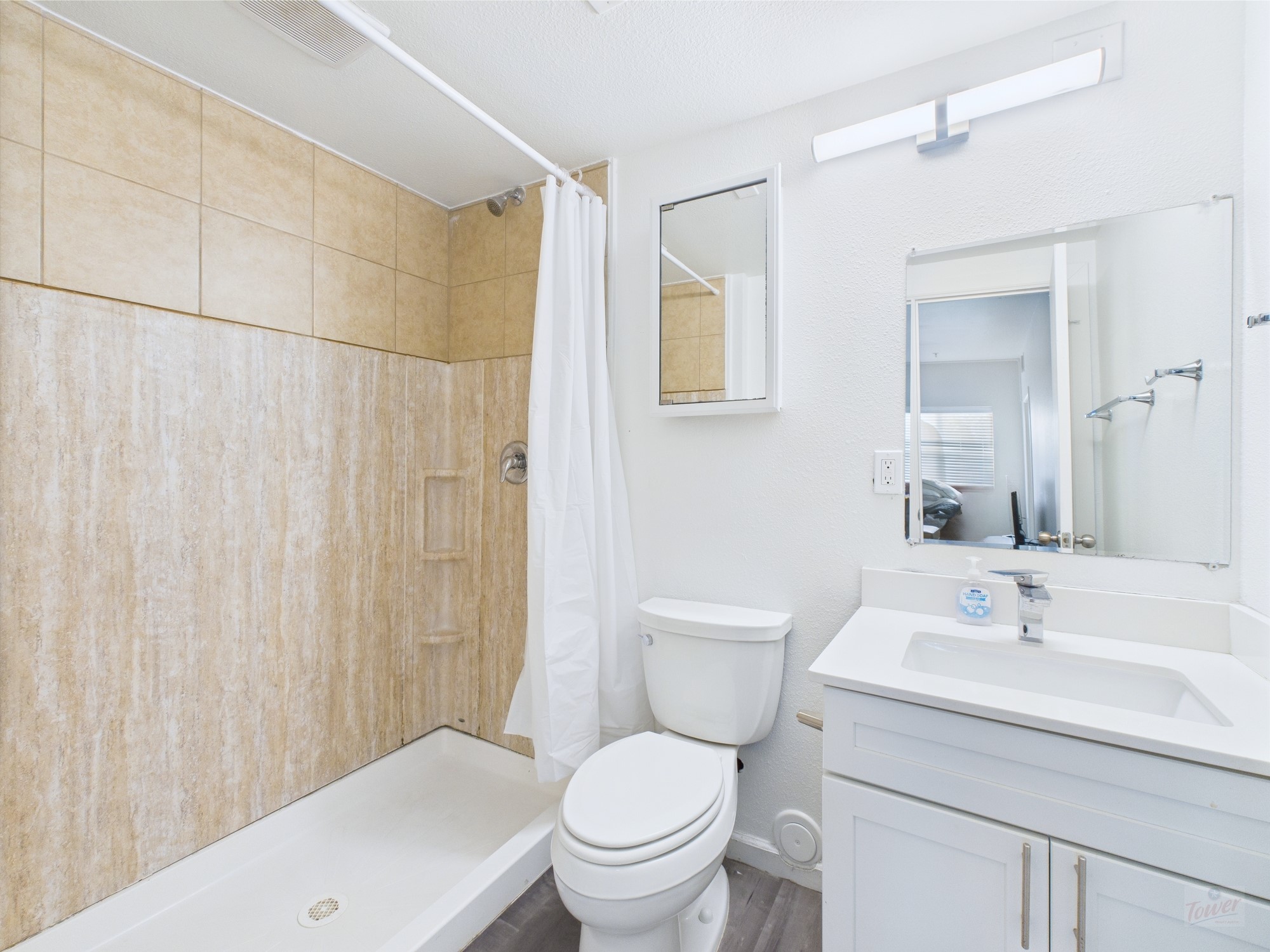 911 West 22nd Street, Unit 306 Austin, TX 78705 - Photo 12 of 12 a bathroom with a toilet a sink and a mirror
