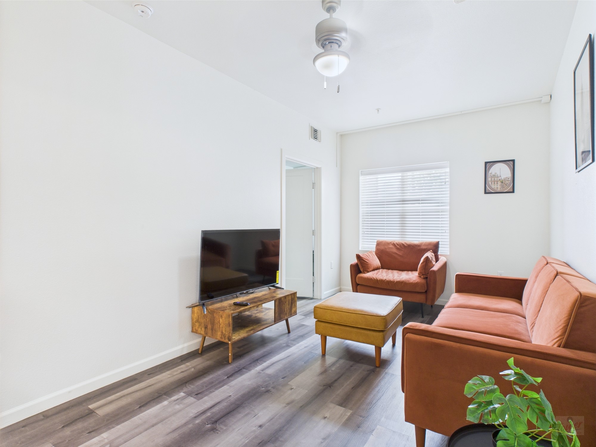 911 West 22nd Street, Unit 306 Austin, TX 78705 - Photo 3 of 12 a living room with furniture and a flat screen tv