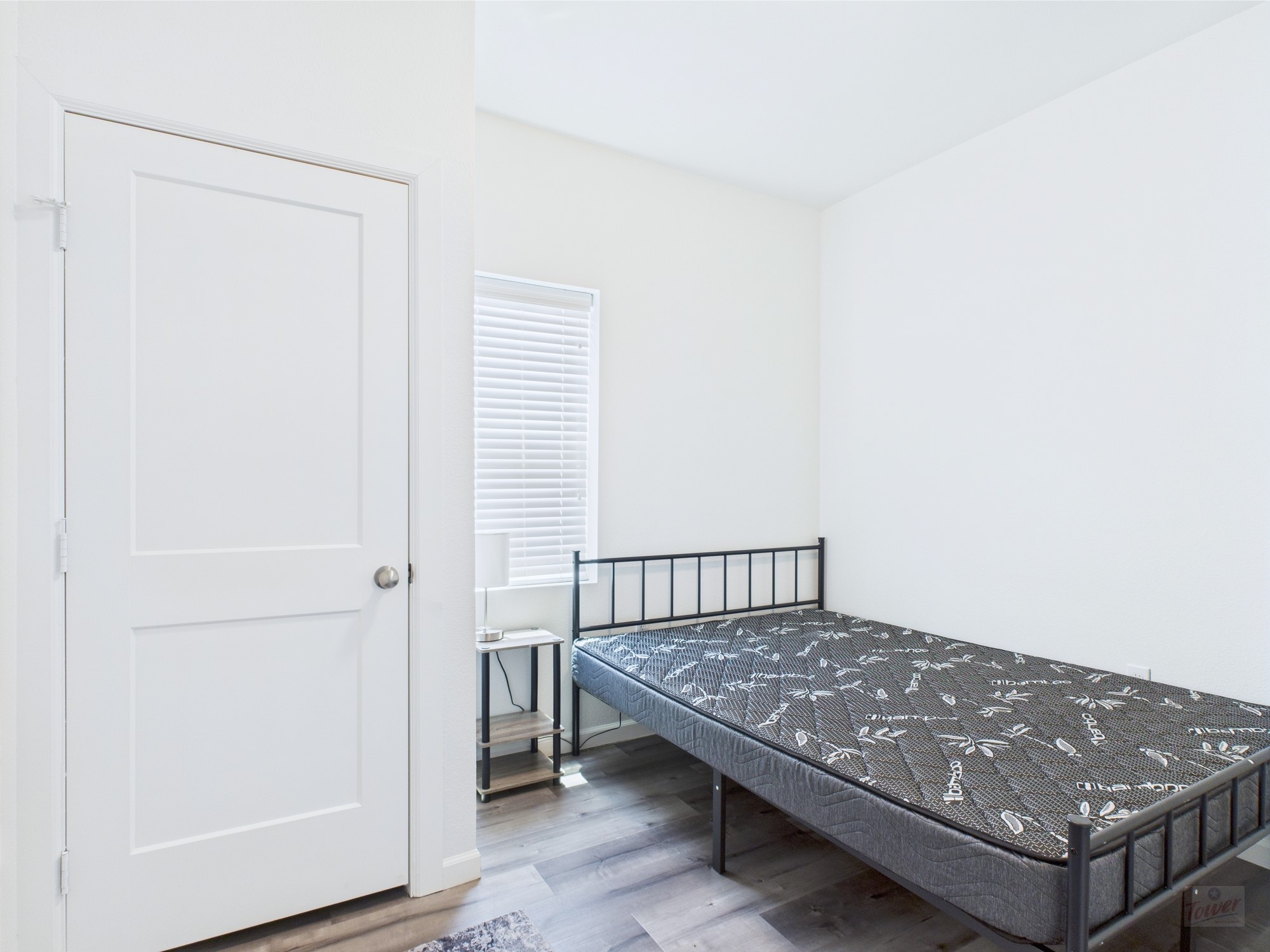 911 West 22nd Street, Unit 306 Austin, TX 78705 - Photo 10 of 12 a view of a bedroom with a bed and wooden floor